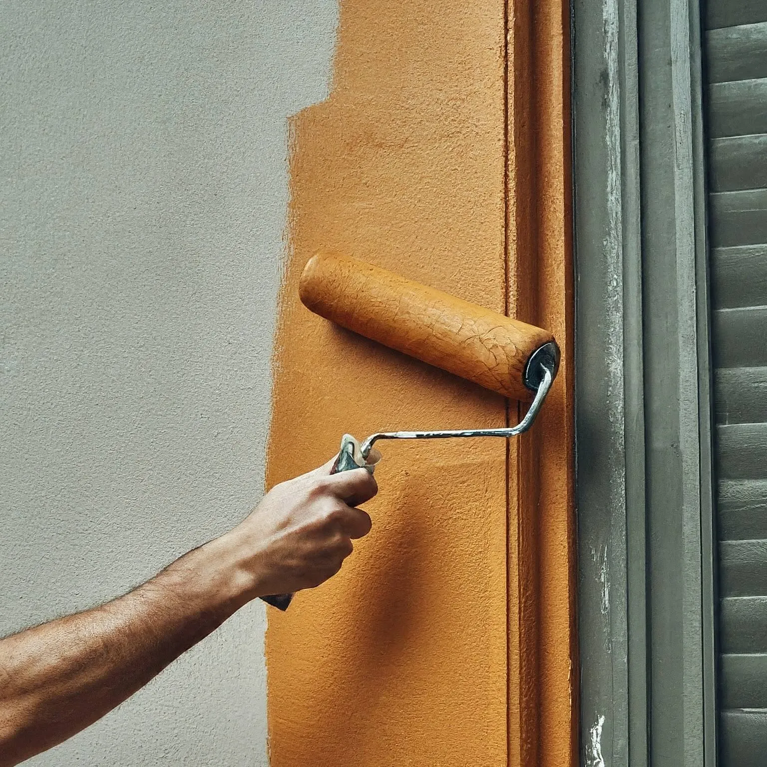 orange paint roller applying color