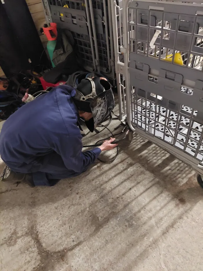 technician kneeling down to repair the cart
