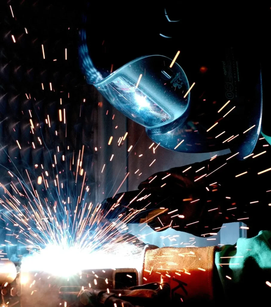 close-up of a welder in a protective helmet